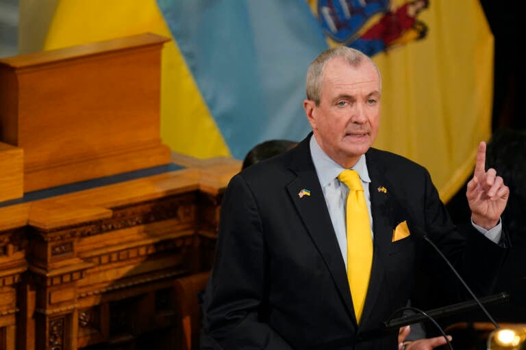 Standing in front of the flags of New Jersey, and Ukraine, New Jersey Gov. Phil Murphy speaks during his budget address in Trenton, N.J., Tuesday, March 8, 2022. (AP Photo/Seth Wenig)