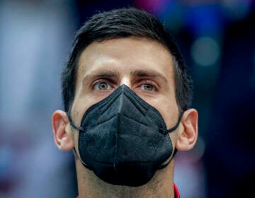 File photo: Serbia’s Novak Djokovic wears a face mask as he listens to the national anthems prior to a Davis Cup group F match between Serbia and Austria in Innsbruck, Austria, Friday, Nov. 26, 2021. (Photo/Michael Probst)