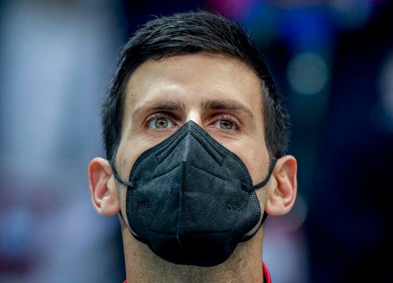 File photo: Serbia’s Novak Djokovic wears a face mask as he listens to the national anthems prior to a Davis Cup group F match between Serbia and Austria in Innsbruck, Austria, Friday, Nov. 26, 2021. (Photo/Michael Probst)