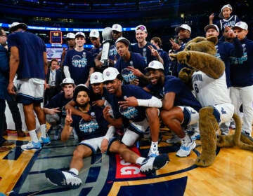 Villanova players pose with the tournament trophy after defeating Creighton in the final of the Big East conference tournament Saturday, March 12, 2022, in New York