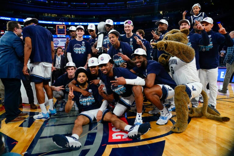 Villanova players pose with the tournament trophy after defeating Creighton in the final of the Big East conference tournament Saturday, March 12, 2022, in New York