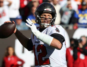 File photo: Tampa Bay Buccaneers quarterback Tom Brady (12) throws a pass against the Los Angeles Rams during the first half of an NFL divisional round playoff football game Jan. 23, 2022, in Tampa, Fla. Brady’s retirement lasted 40 days. He said Sunday, March 13, 2022, he is returning to the Buccaneers for his 23rd season in the NFL