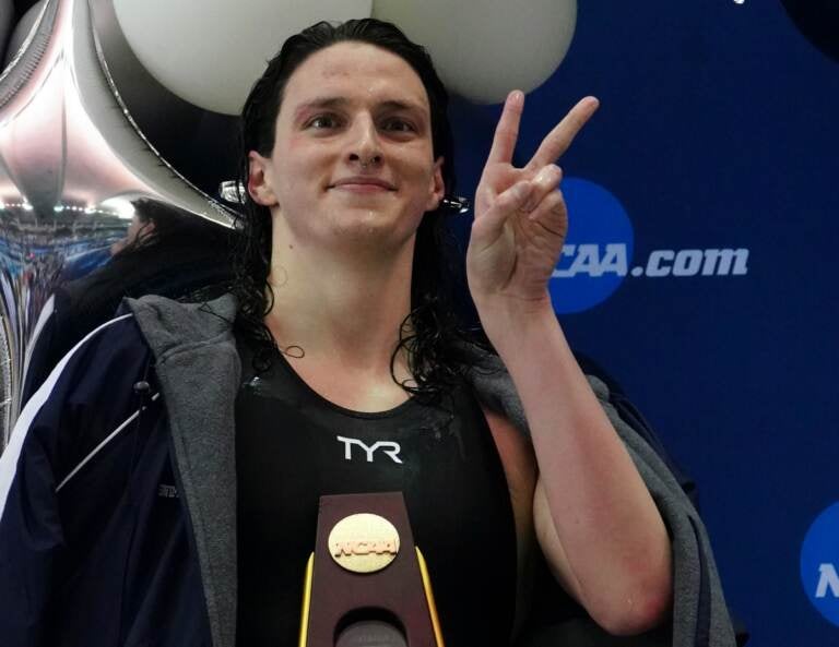 Pennsylvania's Lia Thomas gestures as she holds the trophy after winning the 500-yard freestyle at the NCAA swimming and diving championships Thursday, March 17, 2022, at Georgia Tech in Atlanta. Thomas is the first known transgender woman to win an NCAA swimming championship