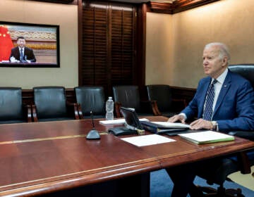 In this image provided by the White House, President Joe Biden meets virtually from the Situation Room at the White House with China’s Xi Jinping, Friday, March 18, 2022, in Washington