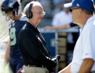 John ''The Professor'' Clayton, an NFL football writer and reporter for ESPN, stands on the sideline during an NFL football game between the Seattle Seahawks and the San Francisco 49ers, Sunday, Sept. 25, 2016, in Seattle. (AP Photo/Ted S. Warren)
