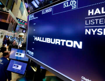 File photo: The logo for Halliburton appears above a trading post on the floor of the New York Stock Exchange, Monday, April 23, 2018. U.S. oil field services companies Halliburton Co. and Schlumberger are suspending their operations in Russia as the Houston, Texas-based businesses react to U.S. sanctions over Russia’s invasion of Ukraine