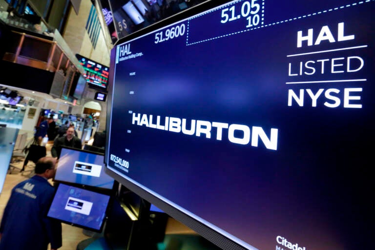File photo: The logo for Halliburton appears above a trading post on the floor of the New York Stock Exchange, Monday, April 23, 2018. U.S. oil field services companies Halliburton Co. and Schlumberger are suspending their operations in Russia as the Houston, Texas-based businesses react to U.S. sanctions over Russia’s invasion of Ukraine