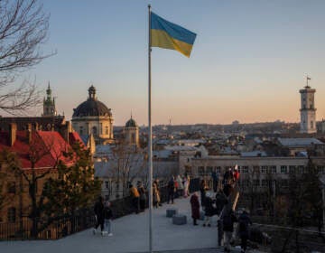 People gather in a vantage point that overlooks the city of Lviv, western Ukraine, Saturday, March 19, 2022. (AP Photo/Bernat Armangue)