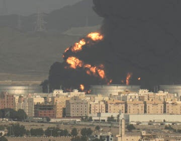 A cloud of smoke rises from a burning oil depot in Jiddah, Saudi Arabia, Friday, March 25, 2022