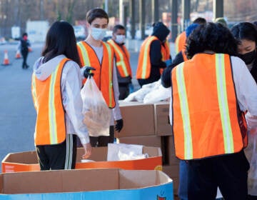 Workers at the Food Bank of South Jersey load food for distribution