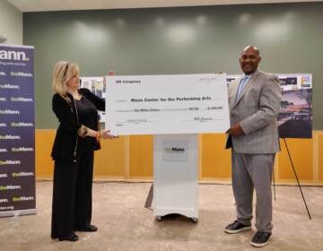 Catherine Cahill, CEO of the Mann Center, receiving $1 million in federal funding from Congressman Dwight Evans. (Peter Crimmins/WHYY)