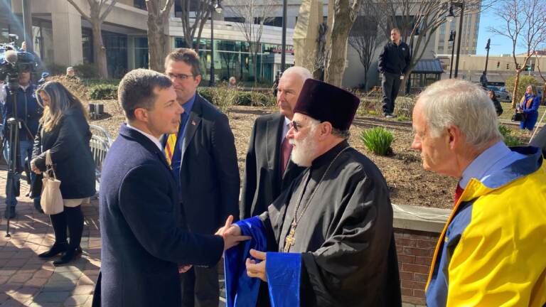 State leaders join Ukrainian ministers and U.S. Sec. of Transportation Pete Buttigieg raising the flag of Ukraine in Freedom Plaza in downtown Wilmington. (Mark Eichmann/WHYY)