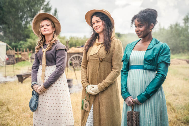 Sanditon-S2Ep1-Red-Planet-Sanditon-2-Ltd016 A young woman (left), Charlotte Heywood (played by Rose Williams) (center), and Georgiana Lambe (Crystal Clarke) (right) standing together outside