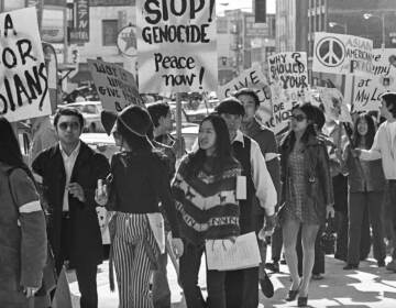 A black and white image of a group of Asian Americans protesting violence against Asians