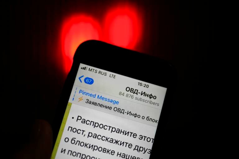 An iPhone screen shows a Telegram account of OVD-Info, prominent legal aid group in Russia that tracks political arrests in Moscow. (Alexander Zemlianichenko/AP)