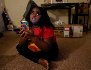 Brooklynn Chiles glances up from her smart phone at home