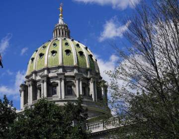 The State Capitol in Harrisburg is shown, with a blue sky in the background.