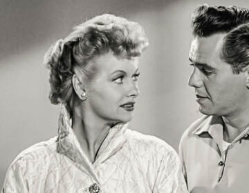 Black and white image of Lucille Ball and Desi Arnaz looking at each other