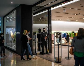 Customers queue to enter a re-opened Zara