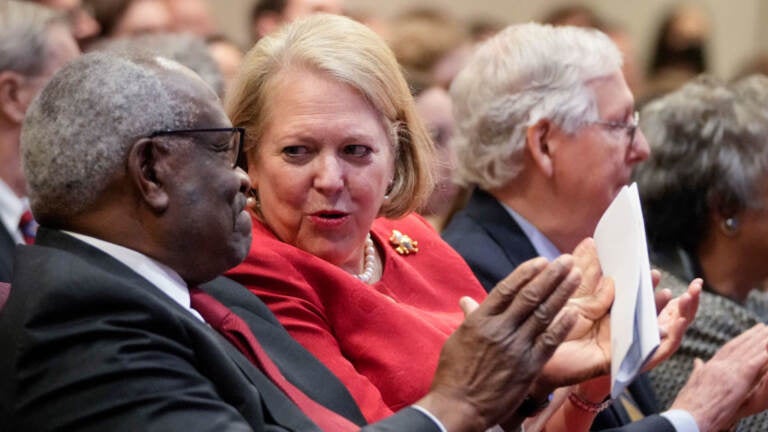 Supreme Court Justice Clarence Thomas sits with his wife, conservative activist Ginni Thomas, at a Heritage Foundation event in October 2021 in Washington, D.C. Ginni Thomas reportedly encouraged efforts to overturn the 2020 election. Supreme Court Justice Clarence Thomas sits with his wife and conservative activist Virginia Thomas while he waits to speak at the Heritage Foundation on October 21, 2021 in Washington, DC.