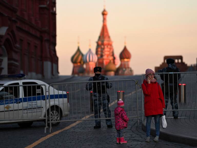 A woman makes a phone call in front of police officers blocking access to Red Square in central Moscow on March 2, 2022 (Kirill Kudryavtsev/AFP via Getty Images)