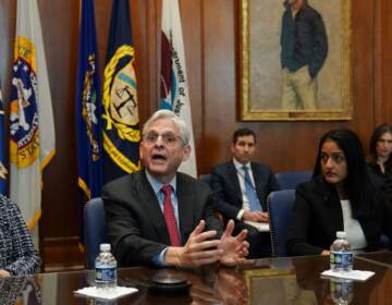 Flanked by US Deputy Attorney General Lisa Monaco (left) and Associate Attorney General Vanita Gupta, Attorney General Merrick Garland convenes a Justice Department component heads meeting in advance of the anniversary of his swearing in, at the Justice Department in  Washington, DC, on March 10, 2022. (Kevin Lamarque//Pool/AFP via Getty Images)