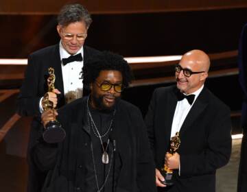 Ahmir 'Questlove' Thompson (C), Robert Fyvolent (L) and David Dinerstein (R) accept the Oscar for best documentary feature for Summer of Soul. (Robyn Beck/AFP via Getty Images)