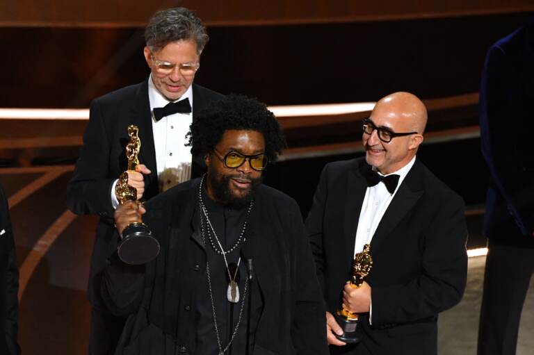 Ahmir 'Questlove' Thompson (C), Robert Fyvolent (L) and David Dinerstein (R) accept the Oscar for best documentary feature for Summer of Soul. (Robyn Beck/AFP via Getty Images)