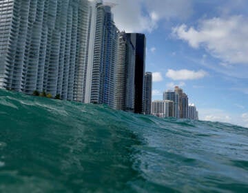 Waves lap ashore near condo buildings in Sunny Isles, Fl., on Aug. 9, 2021.