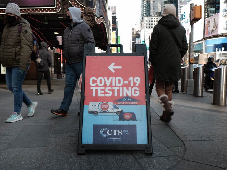 People pass a COVID-19 testing site on a Manhattan street on Jan. 21. The White House says it is running out of money to pay for COVID tests for people who don't have insurance. (Spencer Platt/Getty Images)