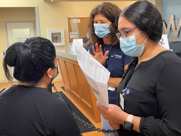 Dr. Megan Werner (center) of Westside Family Healthcare in Wilmington says the root causes of health disparities need to be addressed. (Cris Barrish/WHYY)