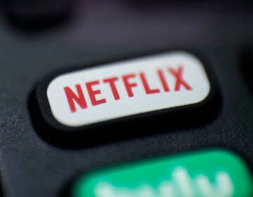 A logo for Netflix on a remote control