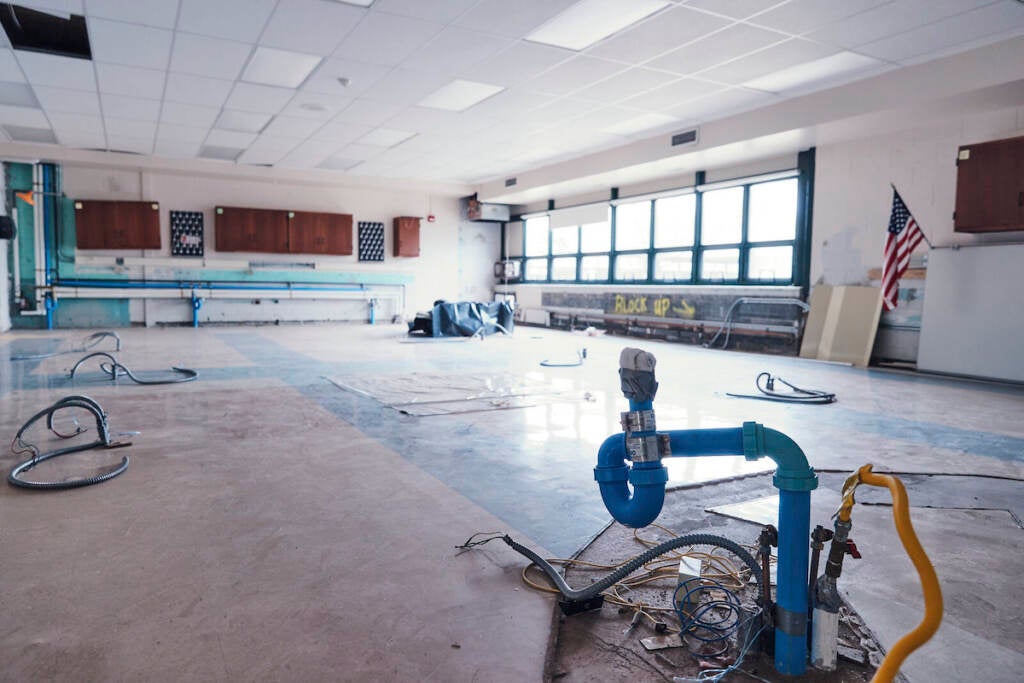 A schoolroom, stripped of furniture, awaits repair.