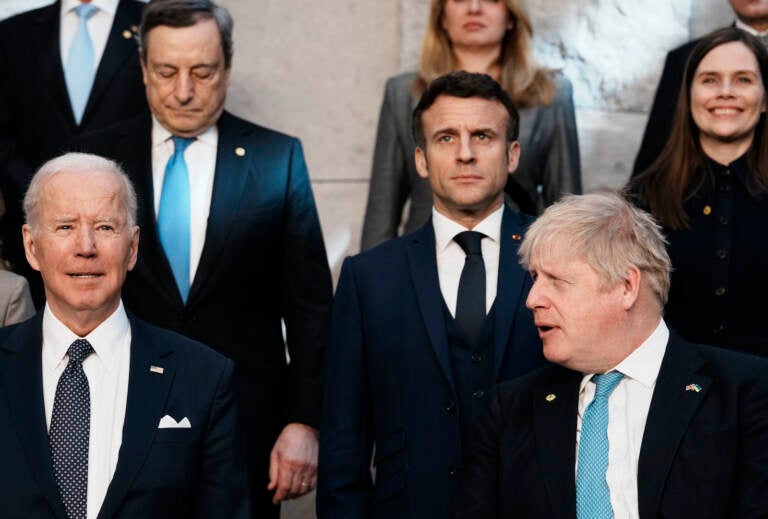 British Prime Minister Boris Johnson, front right, looks toward U.S. President Joe Biden, front left, at a group photo during a NATO summit at NATO headquarters in Brussels