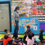 Renada Maddox works with students in her preschool class