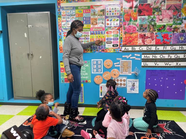 Renada Maddox works with students in her preschool class