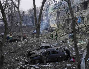 Ukrainian emergency employees work at a maternity hospital damaged by shelling in Mariupol