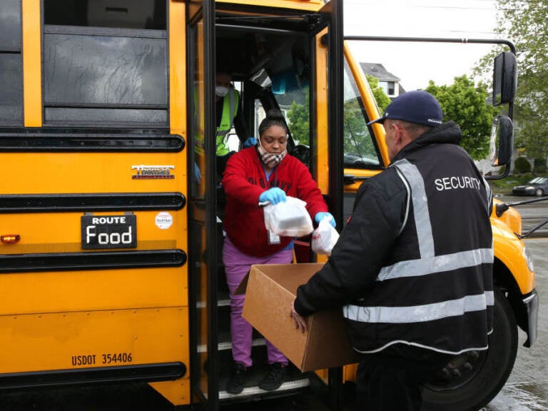 Nutritionist Shaunté Fields and bus driver Treva White (left) deliver meals to children and their families