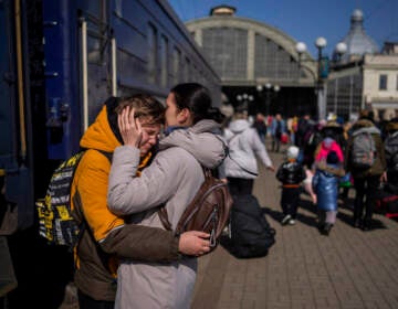 At the train station in Lviv, Ukraine, a mother embraces her son who escaped the besieged city of Mariupol.
