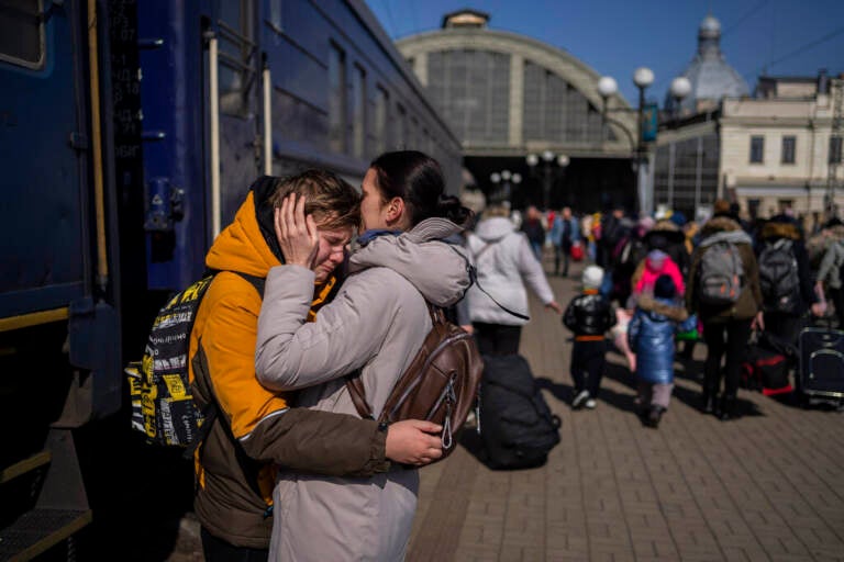 At the train station in Lviv, Ukraine, a mother embraces her son who escaped the besieged city of Mariupol.