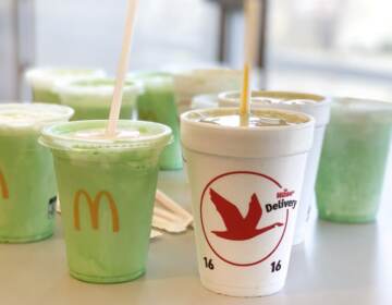 Wawa mint match shakes and McDonald's Shamrock shakes are shown arranged on a table.