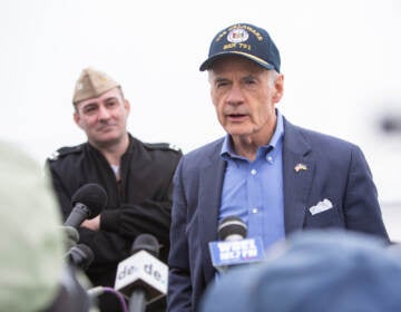 Senator Tom Carper speaks at a podium.