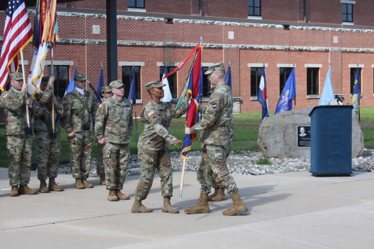 Maj. Gen. Rodney Faulk, commanding general of the Army Reserve's 99th Readiness Division based at Joint Base McGuire-Dix-Lakehurst, passing the colors to Command Sgt. Maj. Subretta Pompey as she assumes the assignment as the top non-commissioned officer in the division. She is also the first African American and first woman to hold that position.