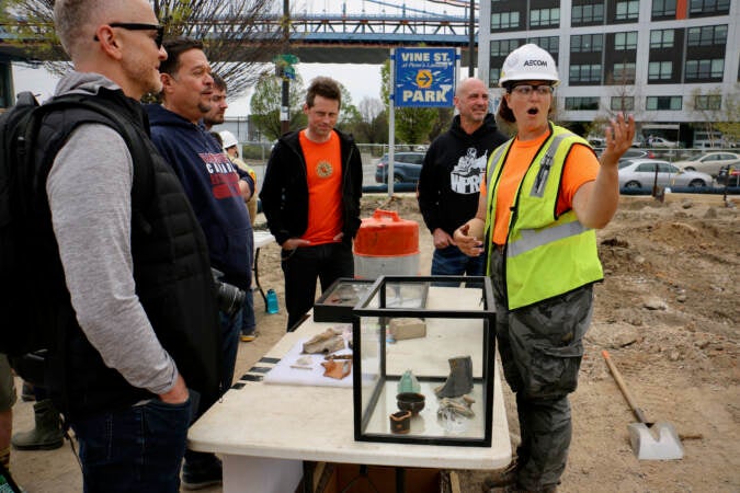 Field archaeologist Caitlyn-Jean Ward speaks to visitors during an open house at the site whcih was at various times a shipyard, a market, and a manufacturing site. (Emma Lee/WHYY)
