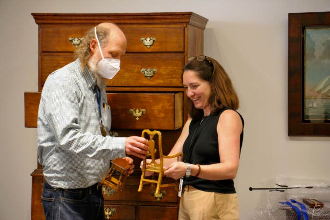 Kevin Tulimieri shows Huntley Platt some antique doll furniture