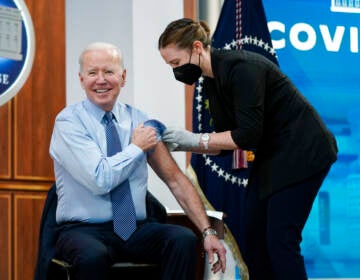 President Joe Biden reacts after receiving his second COVID-19 booster shot in the South Court Auditorium on the White House campus, Wednesday, March 30, 2022, in Washington. (AP Photo/Patrick Semansky)