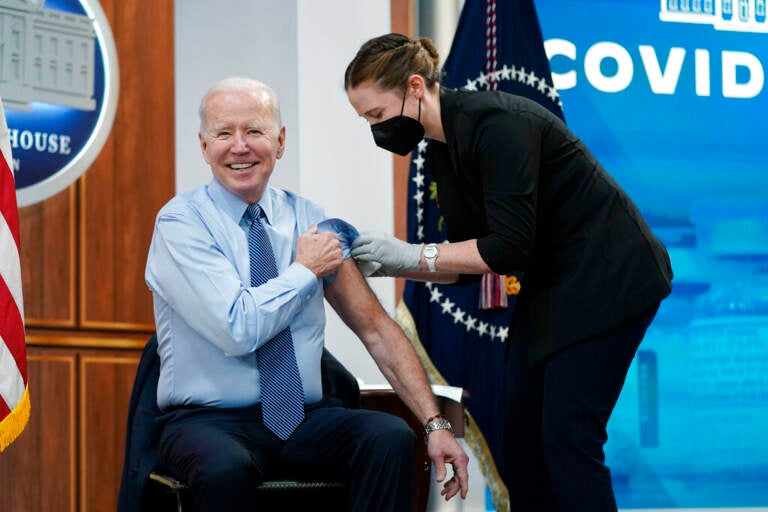 President Joe Biden reacts after receiving his second COVID-19 booster shot in the South Court Auditorium on the White House campus, Wednesday, March 30, 2022, in Washington. (AP Photo/Patrick Semansky)