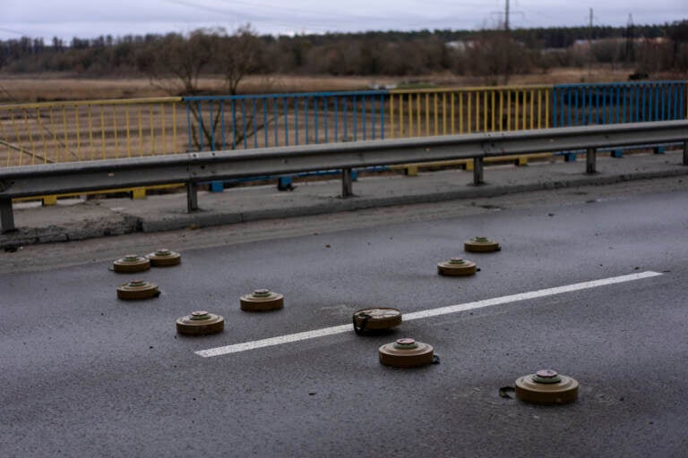 Anti tank mines are displayed on a bridge in Bucha, in the outskirts of Kyiv, Ukraine, Saturday, April 2, 2022. (AP Photo/Rodrigo Abd)