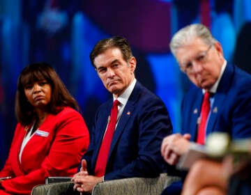 Kathy Barnette, left, Mehmet Oz, and George Bochetto take part in a forum for Republican candidates for U.S. Senate in Pennsylvania at the Pennsylvania Leadership Conference in Camp Hill, Pa., Saturday, April 2, 2022. (AP Photo/Matt Rourke)