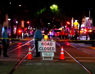 A roadblock is set a block away from the scene of an apparent mass shooting in Sacramento, Calif., Sunday, April 3, 2022.